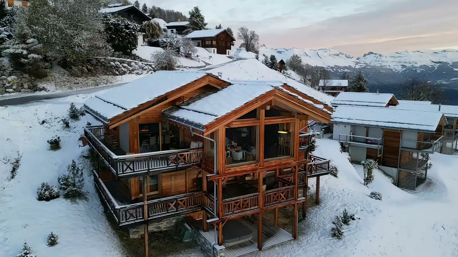The chalet in Les Collons in snow, seen from the drone, with peaks behind